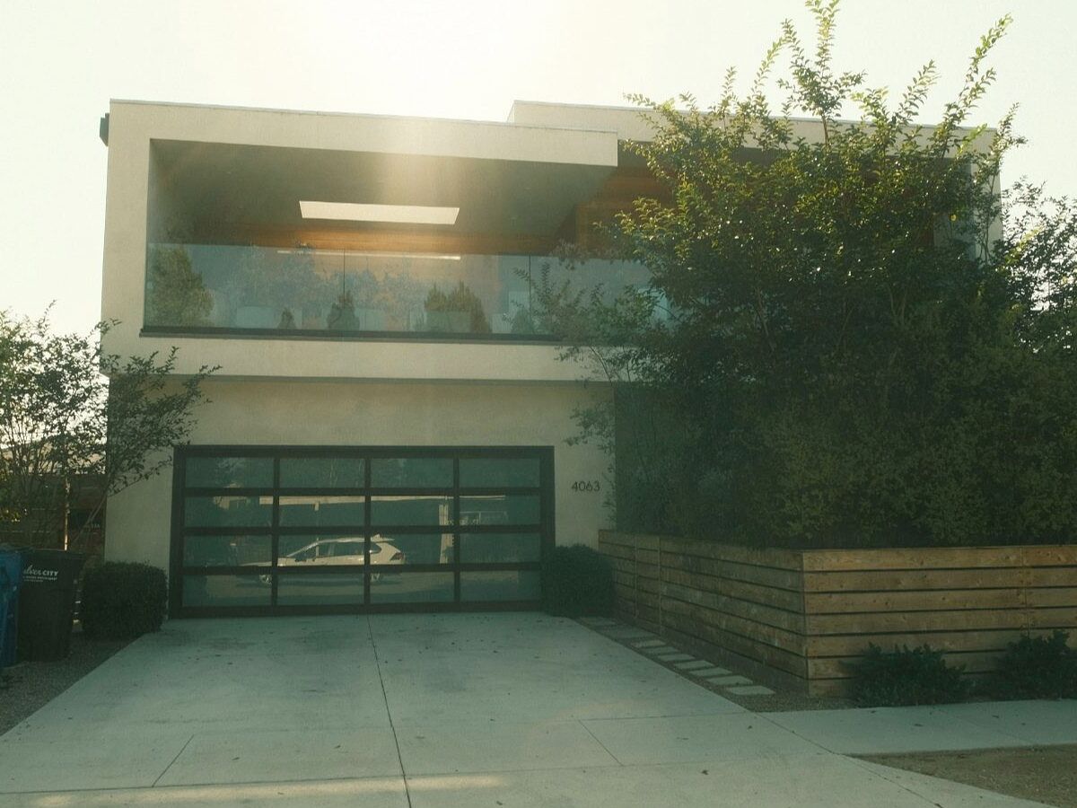 Wide new concrete driveway in front of a modern two-story home