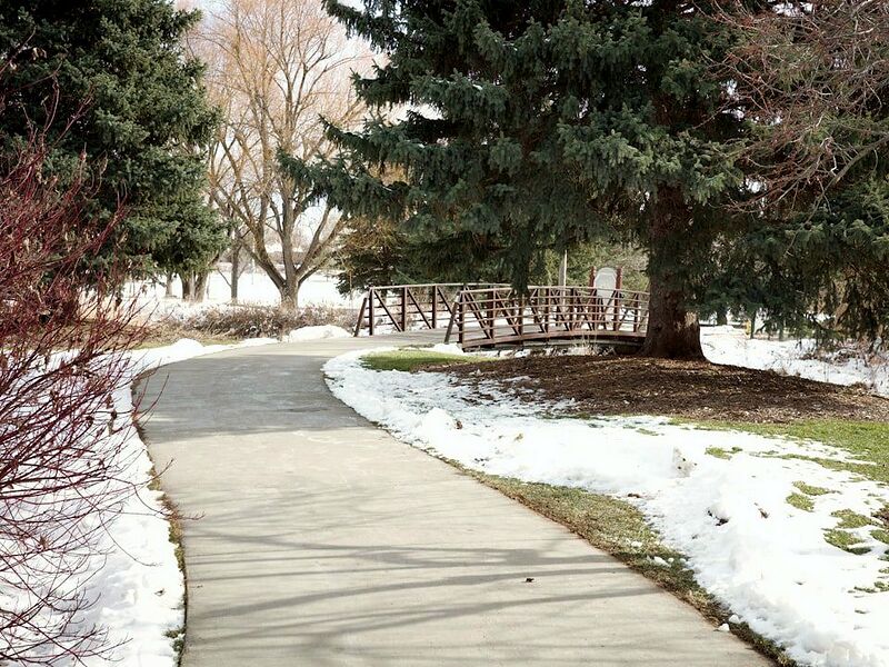 Concrete walkway with snow along both sides