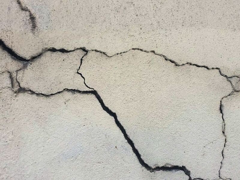 Close-up of cracks running through a concrete slab